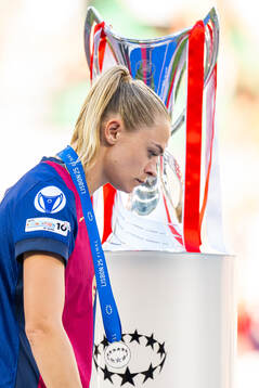 Fridolina Rolfö of Barcelona walks past the trophy