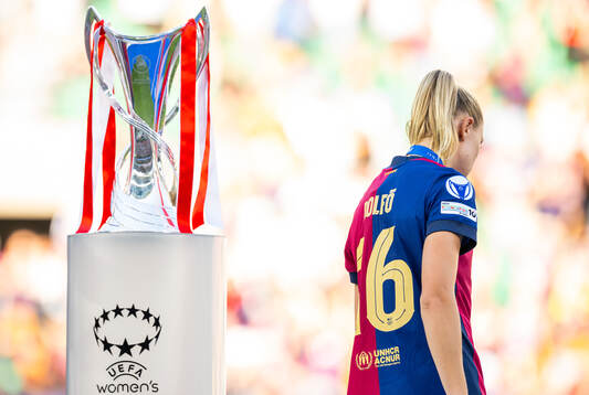 Fridolina Rolfö of Barcelona walks past the trophy