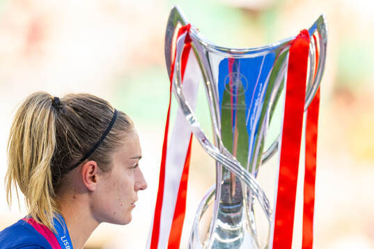 Alexia Putellas of Barcelona walks past the trophy