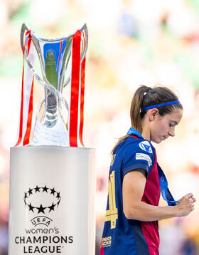 Aitana Bonmati of Barcelona walks past the trophy