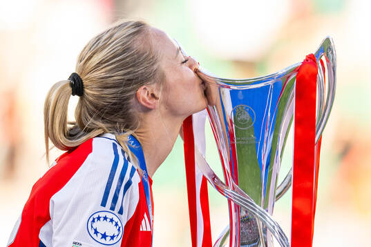 Amanda Ilestedt of Arsenal kisses the trophy