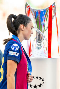 Ingrid Syrstad Engen of Barcelona walks past the trophy