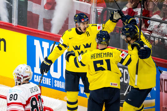 Mikael Backlund celebrates with Emil Heineman and Adam