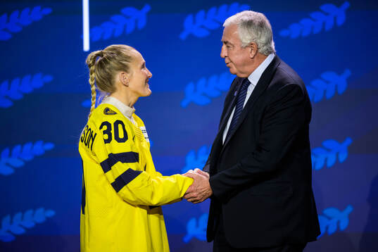 Kim Martin-Hasson of Sweden and IIHF president Luc Tardif