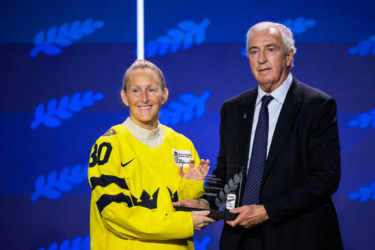 Kim Martin-Hasson of Sweden and IIHF president Luc Tardif