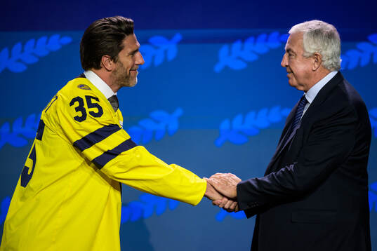 Henrik Lundqvist of Sweden and IIHF president Luc Tardif