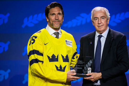Henrik Lundqvist of Sweden and IIHF president Luc Tardif