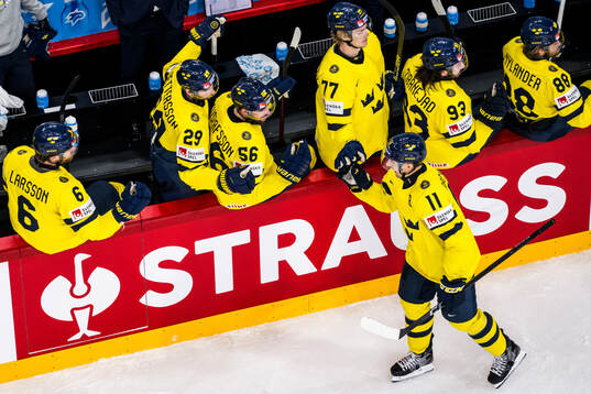 Mikael Backlund of Sweden celebrates with Adam Larsson,
