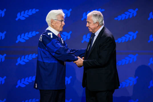 Kai Hietarinta of Finland and IIHF president Luc Tardif
