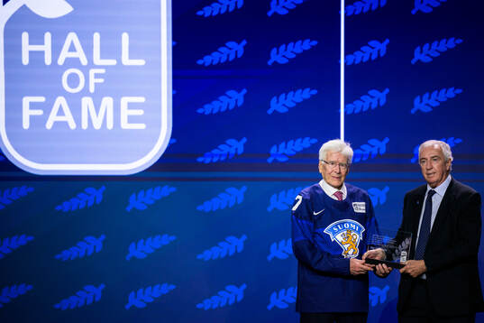Kai Hietarinta of Finland and IIHF president Luc Tardif