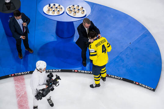 Rasmus Andersson of Sweden receives his bronze medal from