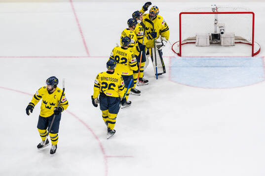 goaltender Samuel Ersson of Sweden with team mates