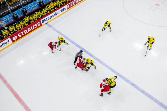Christian Wejse of Denmark face off with Mika Zibanejad of
