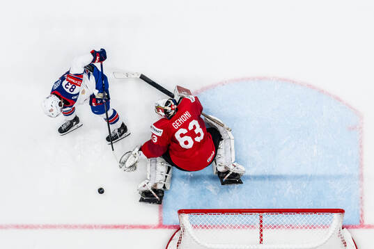 Goaltender Leonardo Genoni of Switzerland saves a penalty