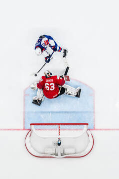 Goaltender Leonardo Genoni of Switzerland saves a penalty