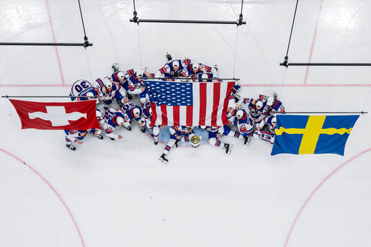 Players of USA celebrate with the trophy in front of team