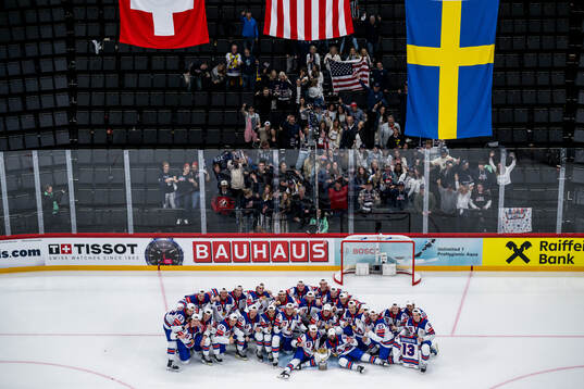 Players of USA celebrate with the trophy in front of team