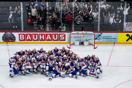 Players of USA celebrate with the trophy in front of team