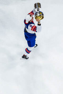 Clayton Keller of USA hoists the winner’s trophy