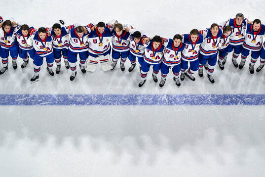 Players of USA sing the American national anthem