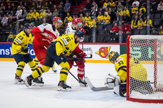 Christian Wejse of Denmark competes for the puck with Erik