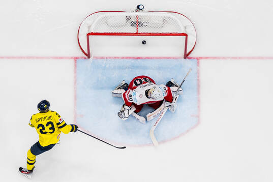 Lucas Raymond of Sweden scores 4-0 past goaltender Frederik