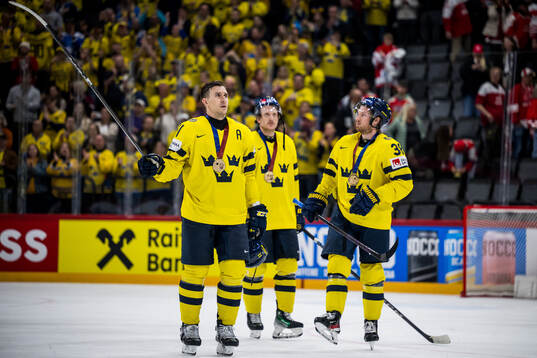 Mikael Backlund and Rasmus Sandin of Sweden recognizes the