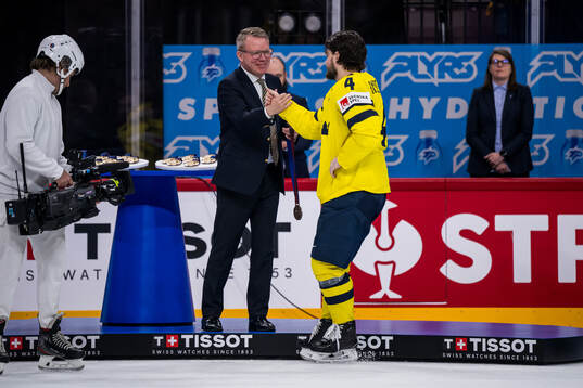Rasmus Andersson of Sweden receives his bronze medal from