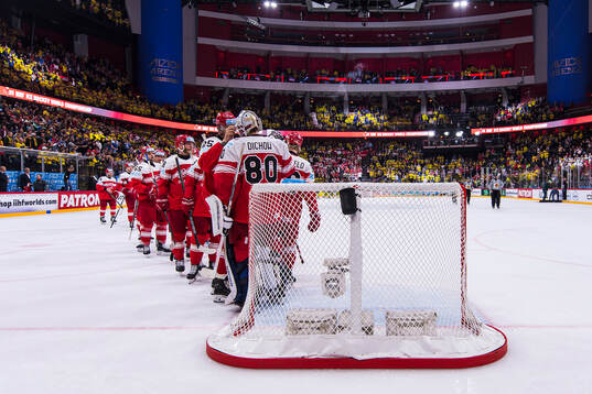 The players of Denmark thank goaltender Frederik Dichow