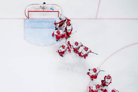 Goaltender Frederik Dichow of Denmark thank his teammates