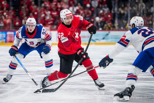 Logan Cooley of USA and Denis Malgin of Switzerland