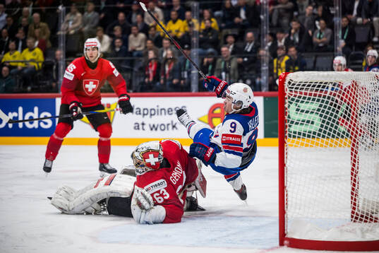 Goaltender Leonardo Genoni and Clayton Keller of USA