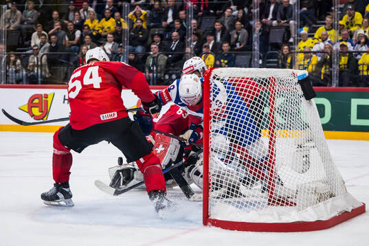 Clayton Keller of USA competes for the puck with Christian