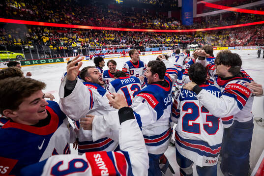 goaltender Jeremy Swayman of USA celebrates with team mates