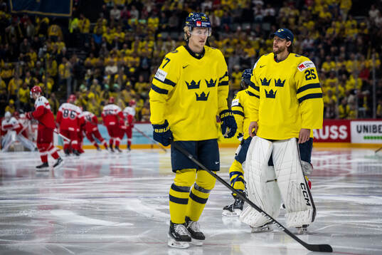 Simon Edvinsson and goaltender Jacob Markström of Sweden