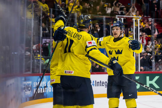 Mikael Backlund and Emil Heineman of Sweden celebrate