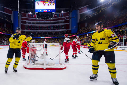 Emil Heineman and Mikael Backlund of Sweden celebrate the