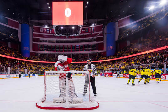 Goaltender Frederik Dichow of Denmark looks dejected