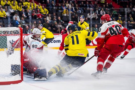 goaltender Frederik Dichow of Denmark and Mikael Backlund