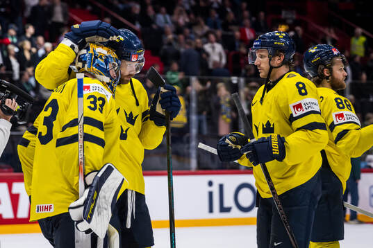 goaltender Samuel Ersson of Sweden celebrates with team