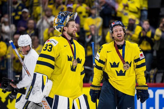 goaltender Samuel Ersson and Rasmus Sandin with their
