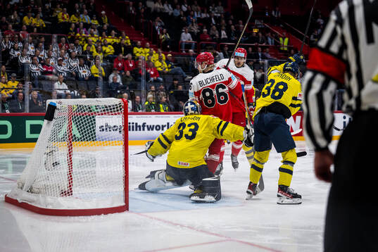 goaltender Samuel Ersson of Sweden and  Joachim Blichfeld