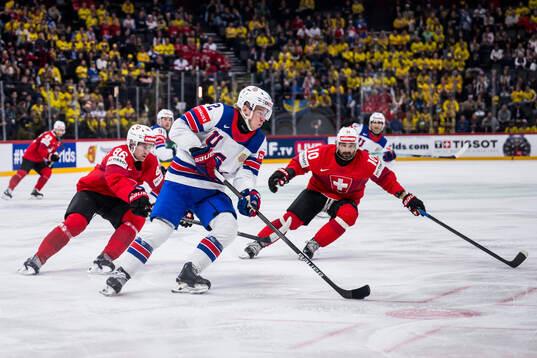 Janis Moser and Andres Ambuhl of Switzerland defend against