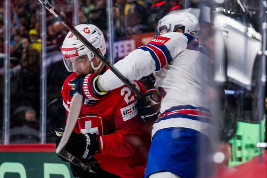 Nino Niederreiter of Switzerland and Zach Werenski of USA