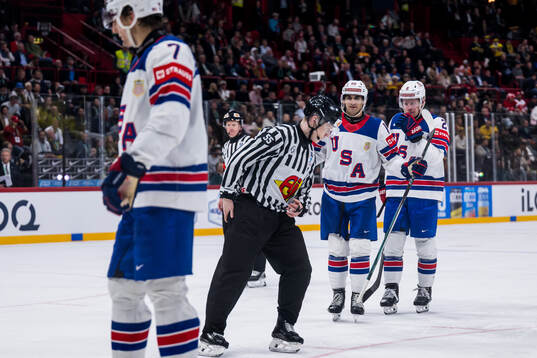 Matty Beniers and Jackson LaCombe of USA react against