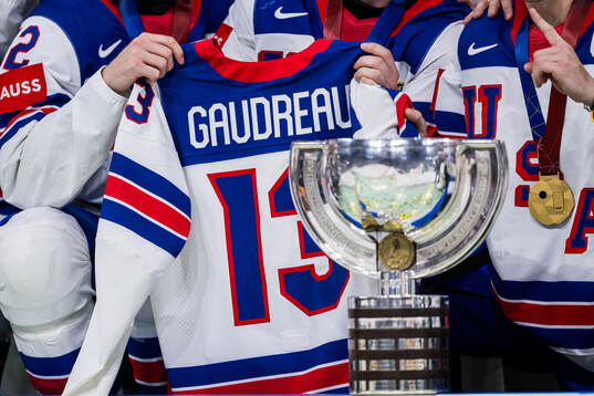 The trophy is seen in front of the jersey of Johnny