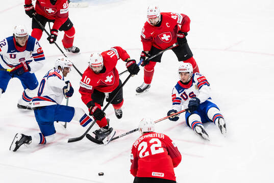 Matty Beniers and Frank Nazar of USA against Andres Ambuhl
