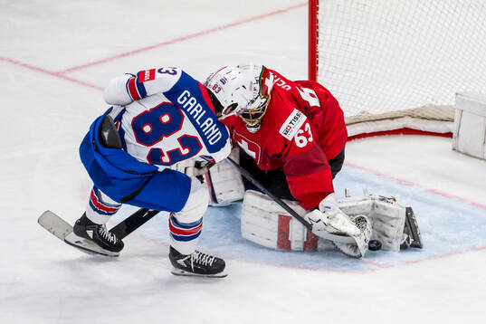 Goaltender Leonardo Genoni of Switzerland saves a penalty