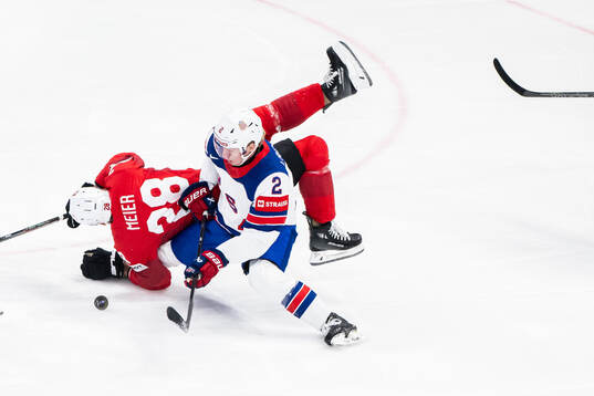 Timo Meier of Switzerland and Jackson LaCombe of USA