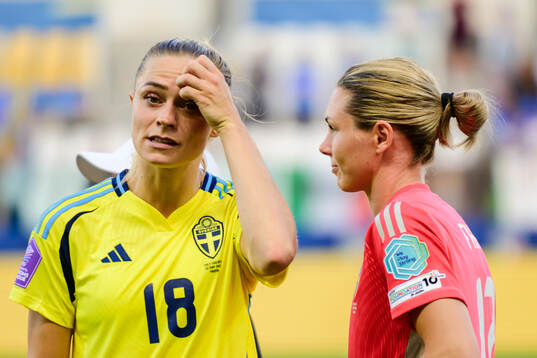 Fridolina Rolfö and goalkeeper Jennifer Falk of Sweden